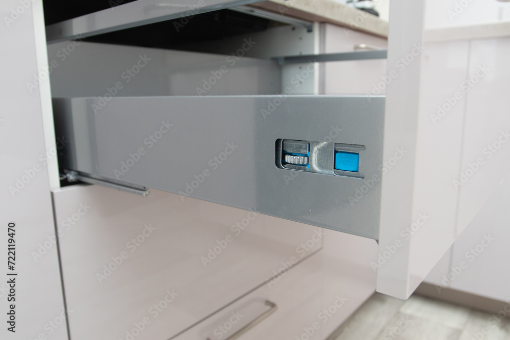 Installing wooden drawer on sliding skids in contemporary cupboard cabinet. Installing wooden drawer on sliding skids in contemporary cupboard cabinet.