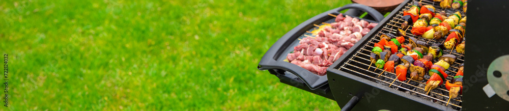 Vegetables and meat are fried on the grill. Selective focus.