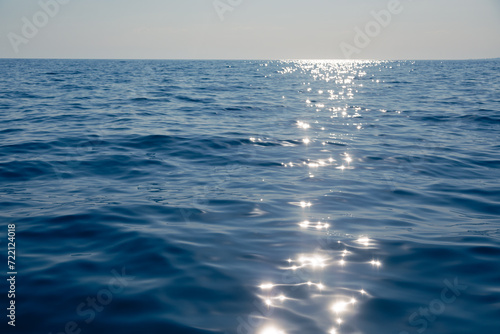 Tranquil sea with glistening sun reflection natural background