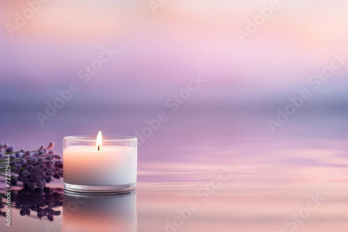 Burning candle with lavender flowers in water on violet background