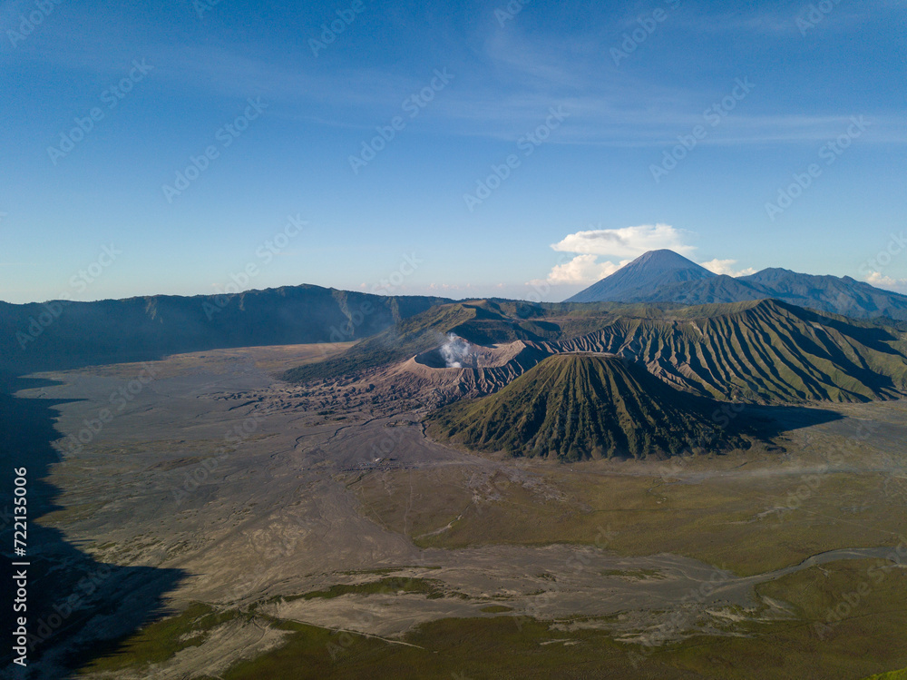 Aerial view of a majestic mountainous landscape with a prominent crater