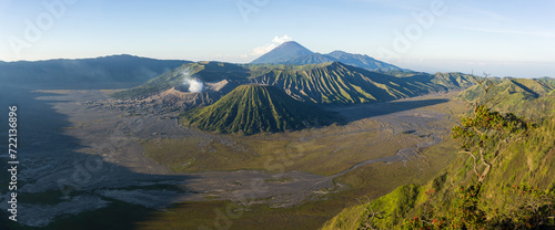 Panoramic view of a majestic volcanic landscape with a smoking crater.