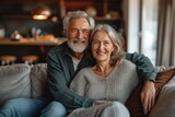 Cheerful mature couple sitting on sofa at home