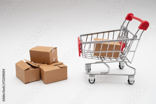 Many cardboard boxes in a small shopping cart. Concepts about online shopping