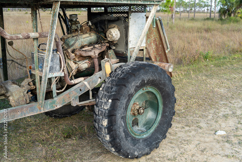 A close-up look of the engine and front wheel of a swamp buggy including the chassis transmission and battery, Turner River Road, Big Cypress NP, Florida