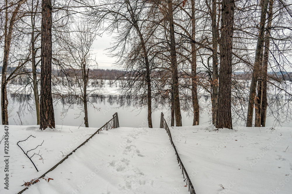 Obraz premium Winter landscape with river, forest at overcast weather.