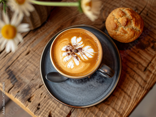 Cup of cappuccino and muffin on wooden table