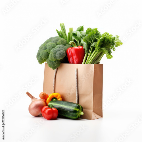 Fresh vegetables in paper shopping bag on white background.