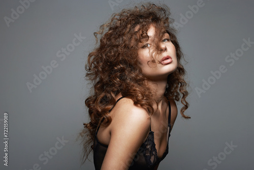 beautiful young woman with curly hair. pretty sexual girl photo