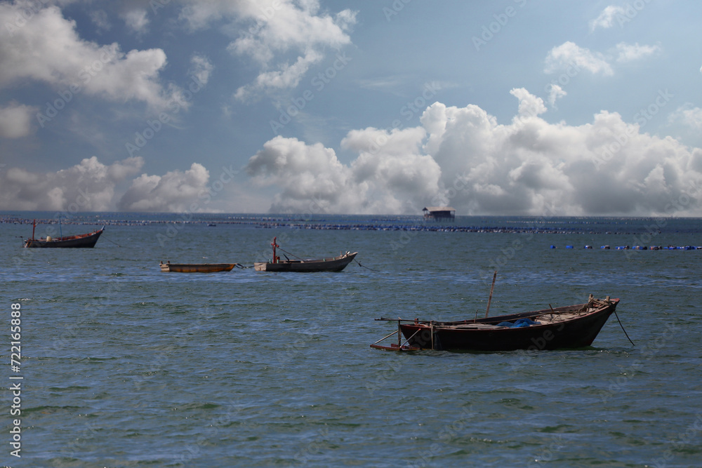 A fishing boat floats in the middle of the sea..