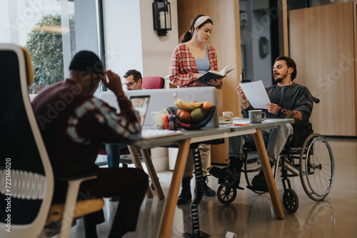 Canvas Print Diverse group of professionals working in a modern office setting, showcasing inclusion with a wheelchair user actively participating