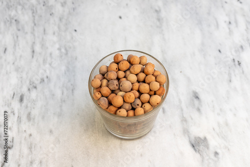 Clay balls for plants in a transparent glass pot photo