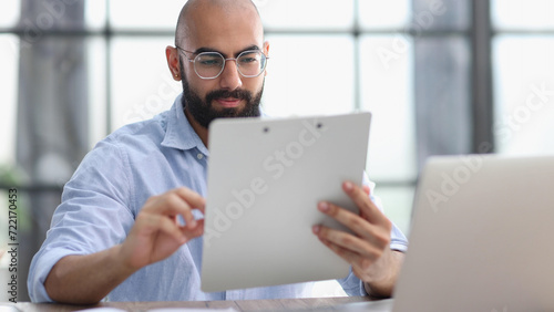 Businessman working on the table with laptop in a new office