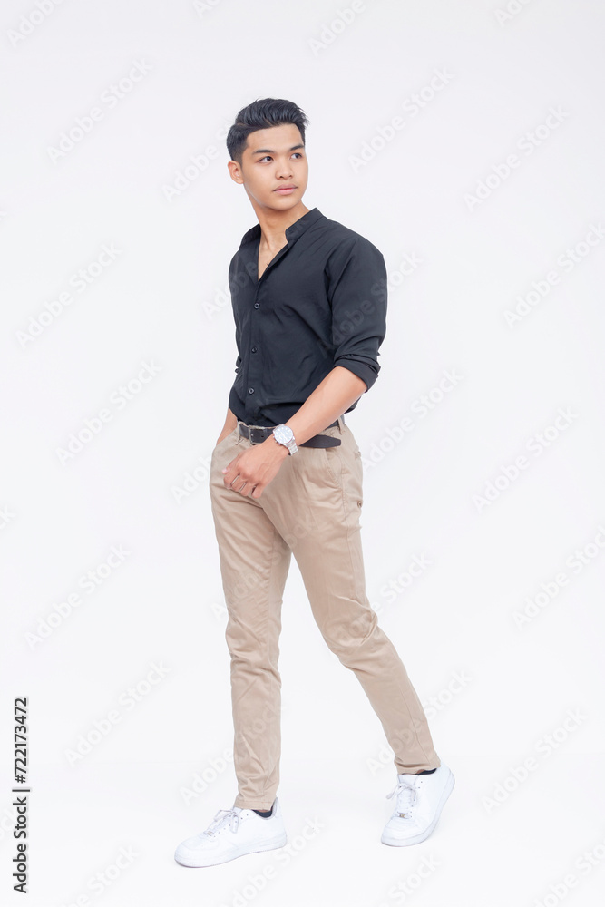 A young Filipino man showcasing casual style, confidently walking against a clean white backdrop, ideal for diverse projects. A young Filipino man showcasing casual style, confidently walking against a clean white backdrop, ideal for diverse projects.