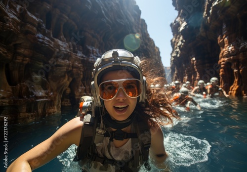 A determined woman conquers the treacherous mountain waters, her face hidden by a helmet and goggles as she swims towards her goal in the great outdoors