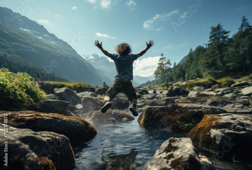 A lone figure embraces the boundless beauty of nature, leaping towards the open sky amidst a stunning landscape of towering mountains, lush trees, rugged rocks, and a tranquil river