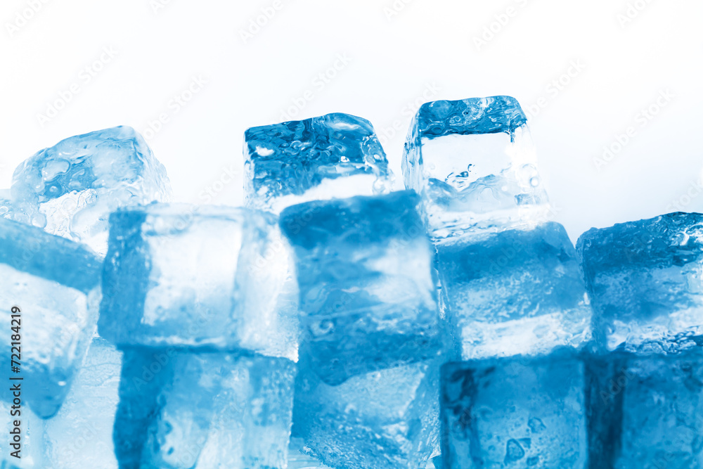Ice cubes isolated white background,Natural crystal clear melting ice cubes on white reflective surface background. Ice cubes isolated white background,Natural crystal clear melting ice cubes on white reflective surface background.