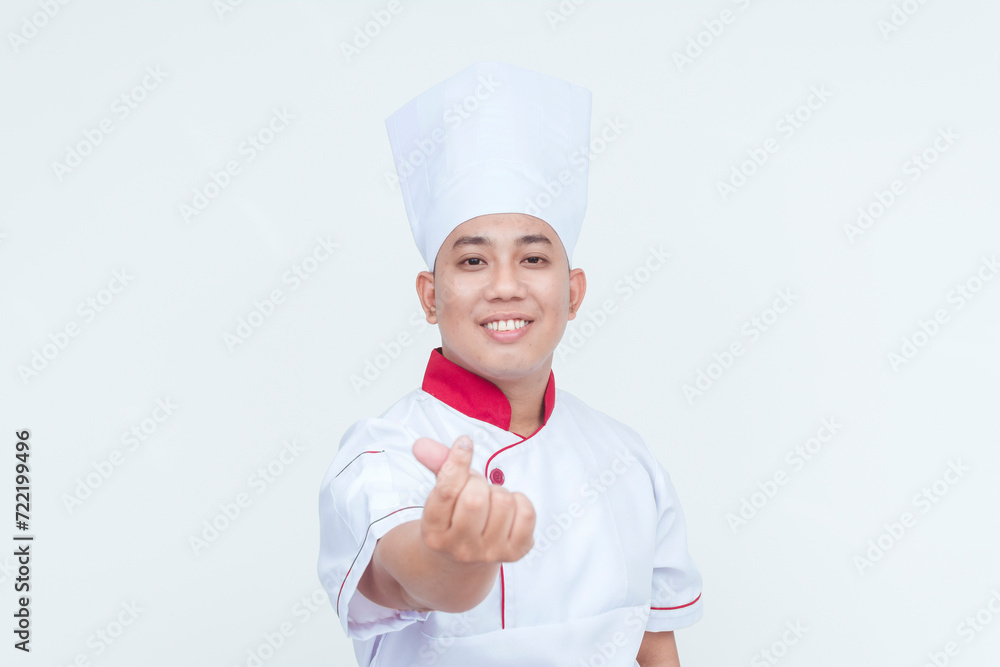Friendly Asian chef in professional attire making a welcoming finger heart gesture, isolated on a white backdrop. Friendly Asian chef in professional attire making a welcoming finger heart gesture, isolated on a white backdrop.