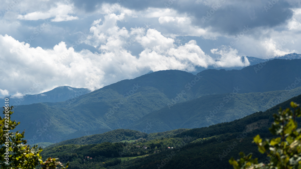 Mountain village against mountains in haze, countryside near Prozor in Bosnia and Herzegovina, mountain landscape
