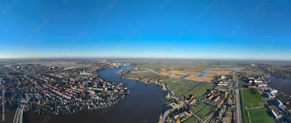 Zaanse Schans, touristic destination of a typical old dutch heritage landscape. Engineering marvel in the polder. Birds eye aerial drone view. 180 degrees aerial panorama.