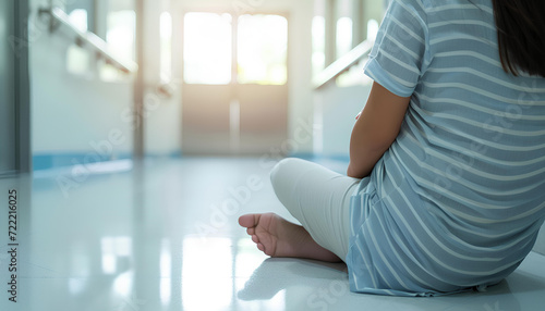 Mid section of pregnant woman sitting in white hospital corridor Free Download Mid section of pregnant woman sitting in white hospital corridor - GFXLoad