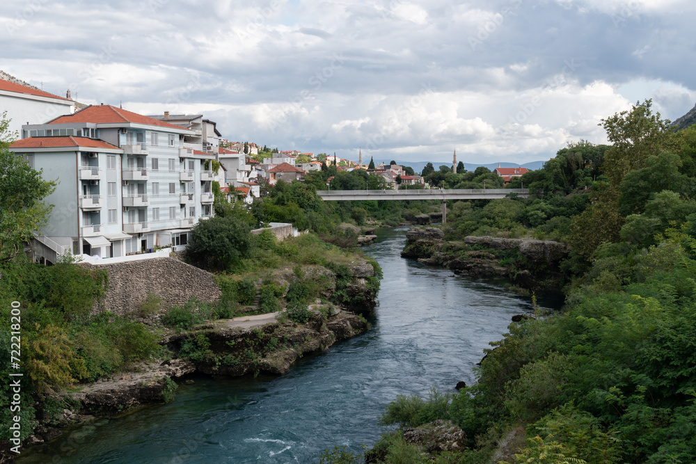 Pedestrian bridge in Mostar over Neretva river, cityscape