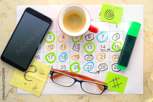 Calendar with business appointments,smartphone,text marker,coffee cup and spectacles, monthly schedule. Business concept,beat the clock.
