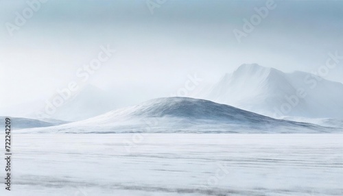 Minimalist snowy landscape with subtle undulations and distant mountains shrouded in mist © Red Lemon