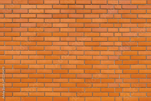 The wall is made of old red brick.