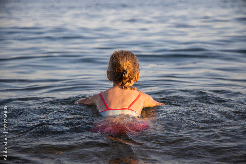 Girl swims in the sea