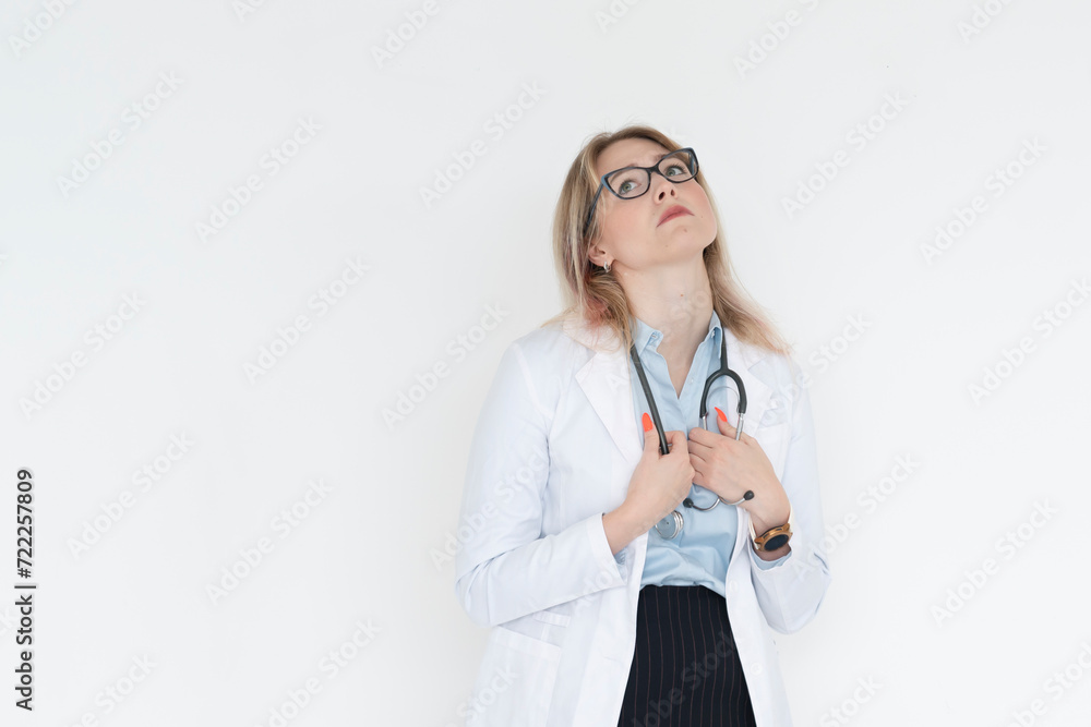 Close up portrait of tired female doctor with headache standing isolated on white background Close up portrait of tired female doctor with headache standing isolated on white background