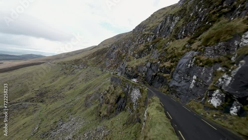  aerial footage following white car over the Dingle Peninsula, County Kerry, Ireland at the beautiful Conor Pass photo