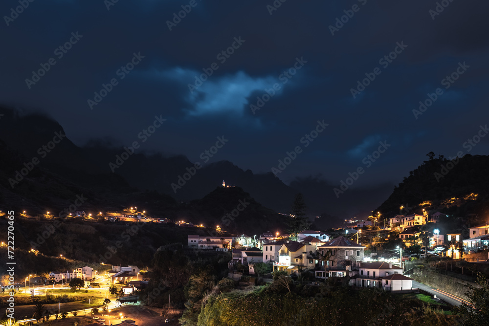 Night-time atmosphere and streetlights of the picturesque village on the north coast in a green, overgrown valley. Sao Vincente, Madeira Island, Portugal, Europe.