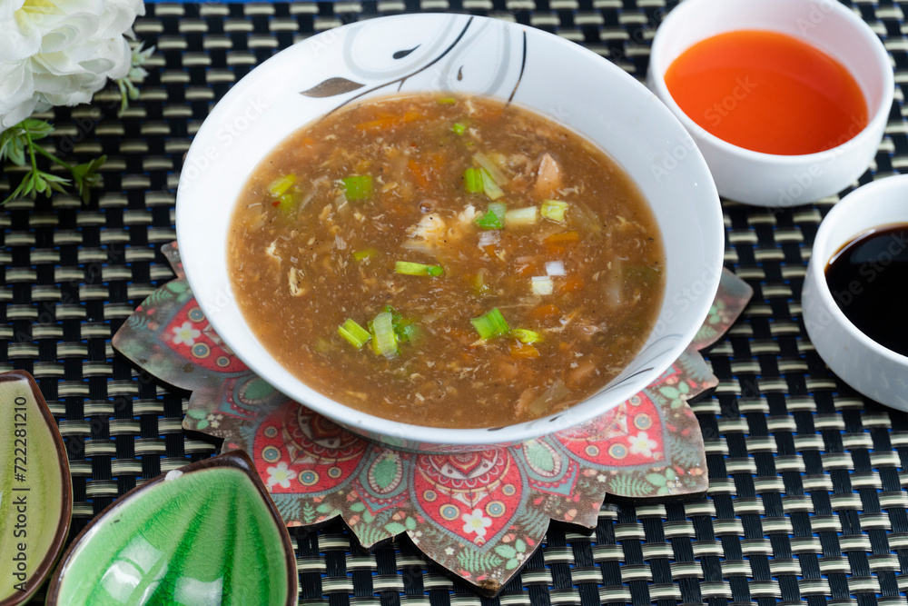 Hot and Sour Soup on textured background Hot and Sour Soup on textured background