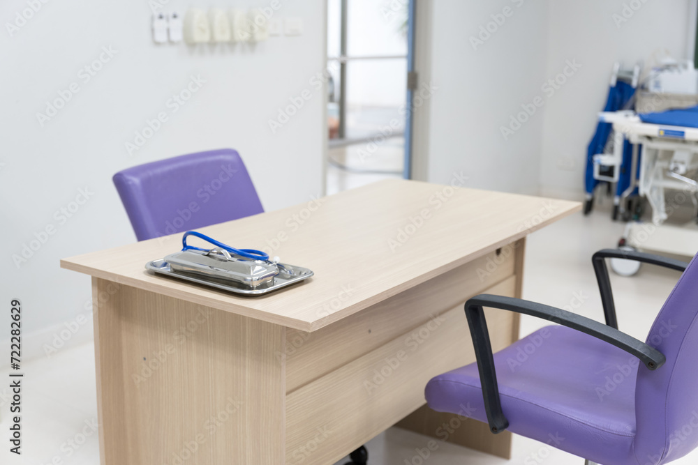 Interior of empty physician office with desk and chairs.Modern and bright doctor office with copy space.Medical tools at doctor working table. Interior of empty physician office with desk and chairs.Modern and bright doctor office with copy space.Medical tools at doctor working table.