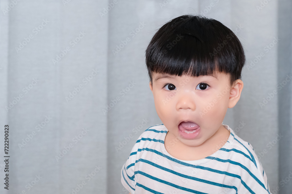Portrait of funny chubby baby toddler with surprised expression, asian baby making funny face isolated on gray background Portrait of funny chubby baby toddler with surprised expression, asian baby making funny face isolated on gray background