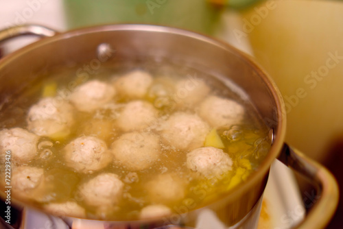 Meatballs are boiled in broth with potatoes