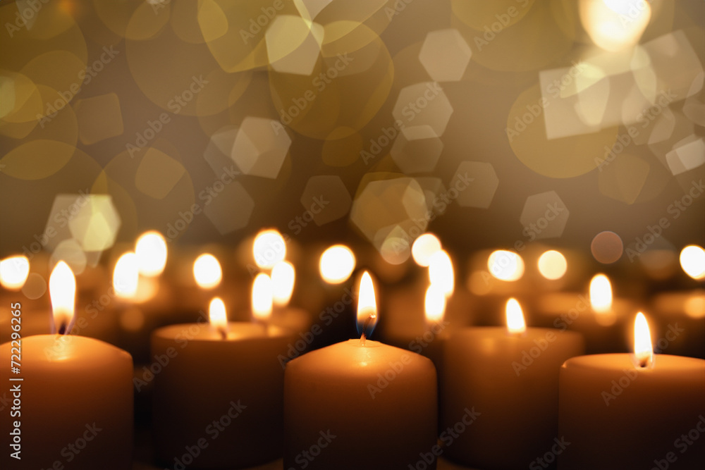 A candle burns on a dark background. Enlarged image of a candle in the dark A candle burns on a dark background. Enlarged image of a candle in the dark