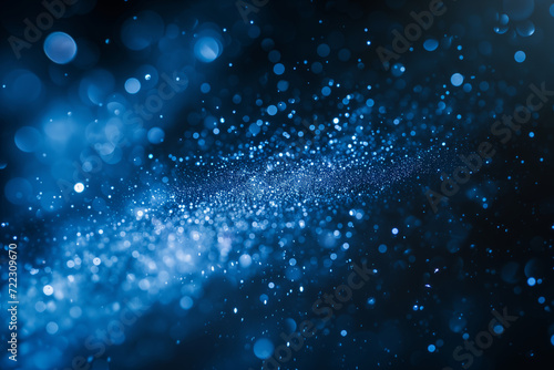 Abstract glittery banner with blue shining particles on back background, sparkling light.