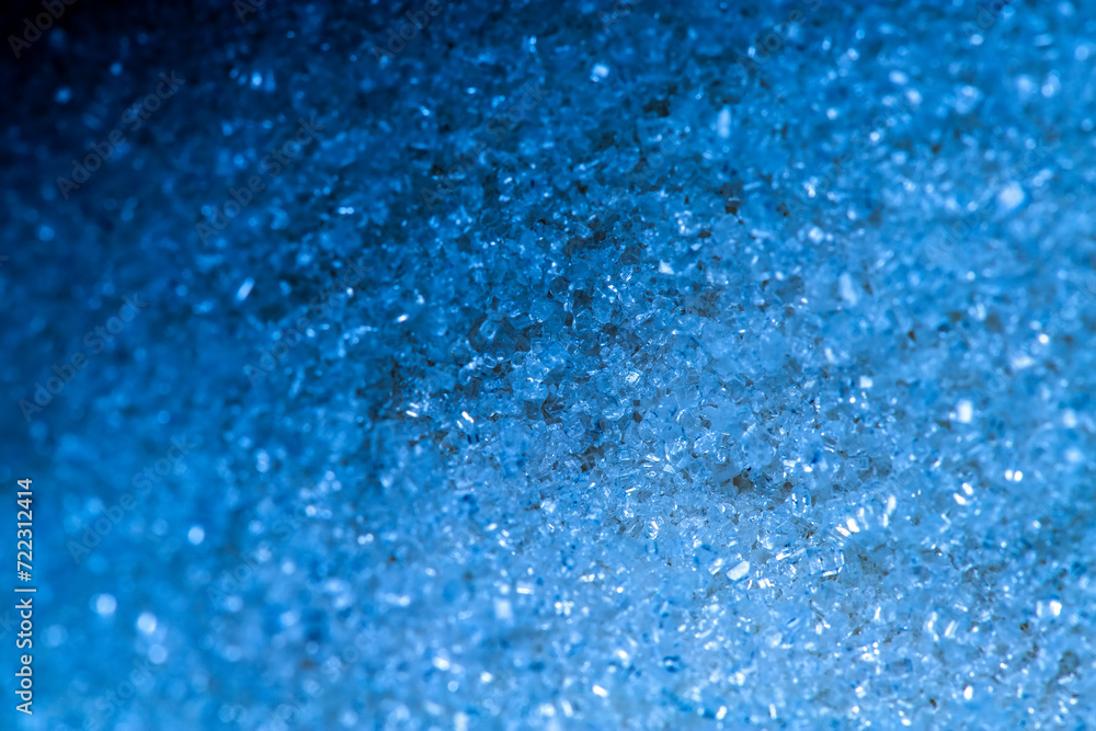 Blue abstract background with sugar crystals. Selective focus.