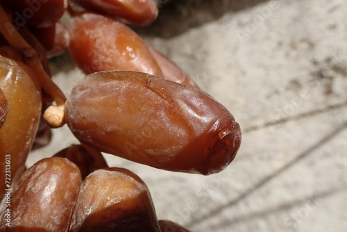 Dates or dattes palm fruit in wooden plate is snack healthy, Set of various dates bowl, Different kind of raw date fruit ready to eat, concrete background, Traditional, delicious and healthy ramadan photo