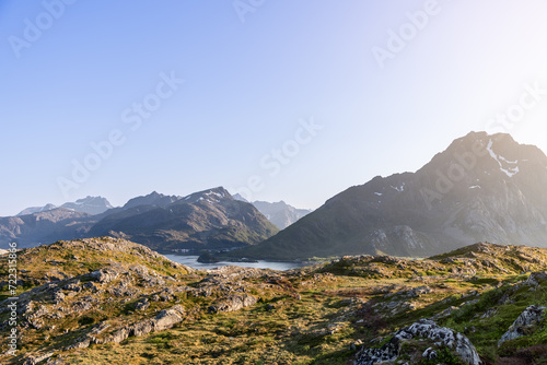Canvas Print The sun casts a golden glow over a rugged landscape, highlighting the textured t
