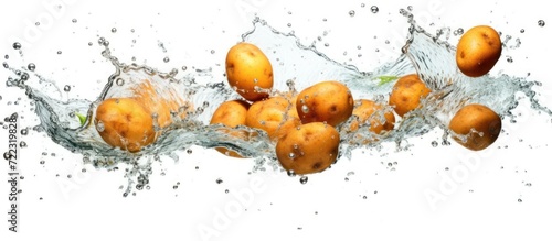 Potatoes splashed in water, isolated white background