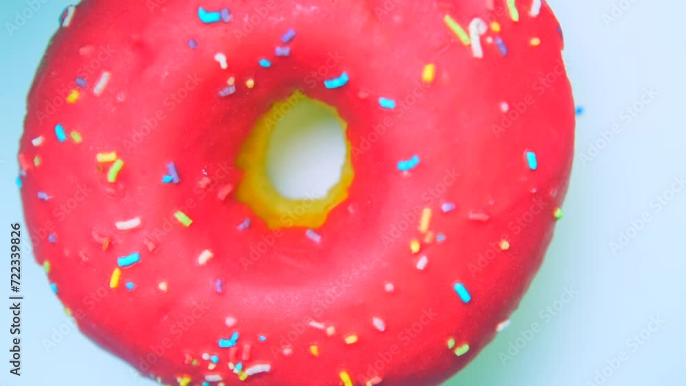 Raspberry and cherry donut spins in a circle on a white surface Raspberry and cherry donut spins in a circle on a white surface