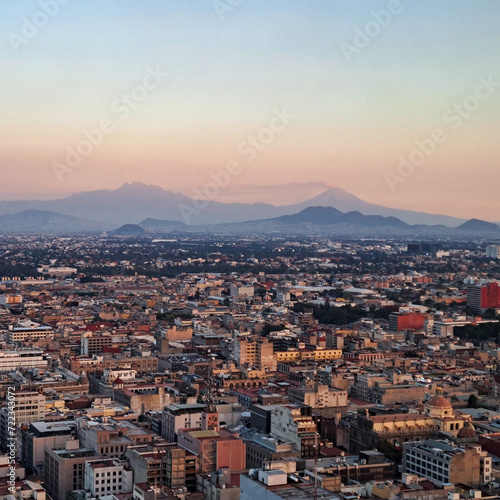 Aereal view of mexico city, in the back volcanos popocatepetl and iztacihuatl