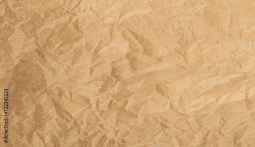 Crumpled yellow craft paper background.