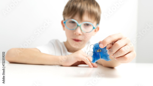 A boy with a tooth alignment plate