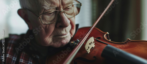 An elderly man lost in a moment of music, his violin a bridge over the silences of dementia, eyes closed in heartfelt expression