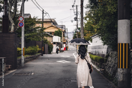 Woman walking with umbrella