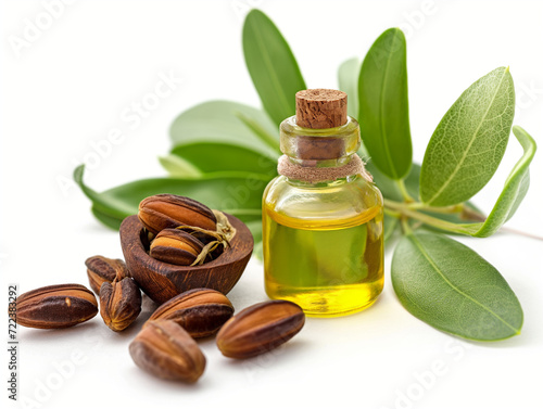 Glass bottle with jojoba oil and seeds on white background